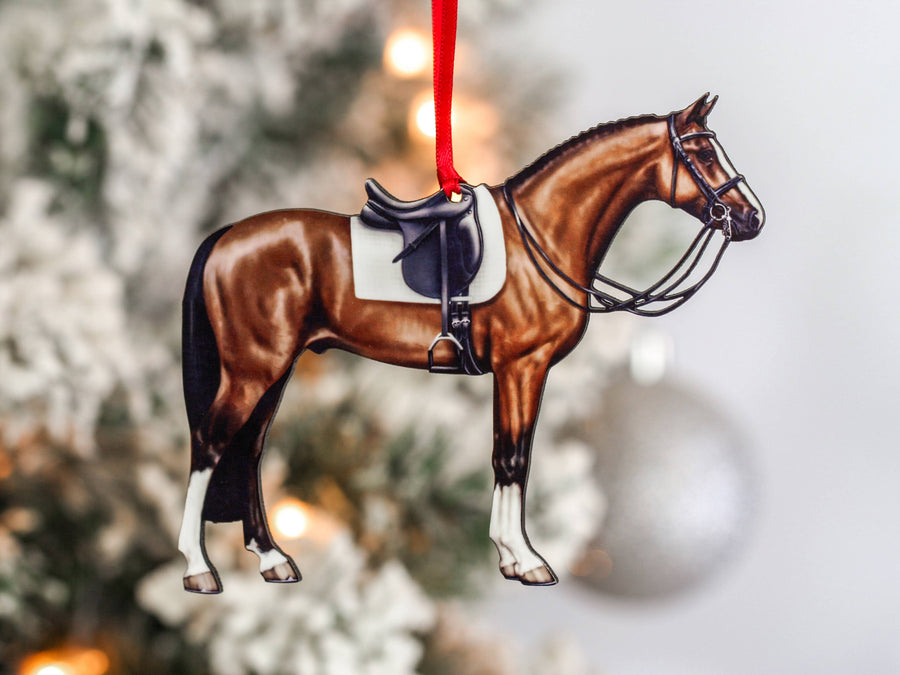 a horse ornament hanging from a christmas tree